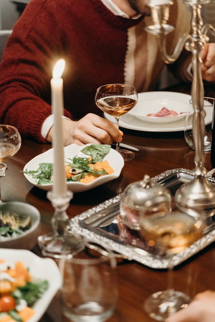 Cozy dinner setting with candlelight and food, capturing warmth and elegance.